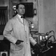 A serene-looking Harry Grindell Matthews standing next to his DEATH RAY.